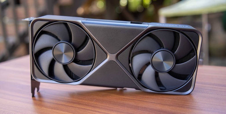 A Founders Edition NVIDIA RTX 5080 sits on a wood desk.