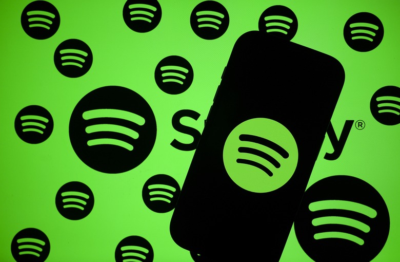 ANKARA, TURKIYE - OCTOBER 24: In this photo illustration the logo of Spotify is being displayed on a mobile phone screen in front of computer screen displaying the logos of Spotify in Ankara, Turkiye on October 24, 2025. (Photo by Muhammed Selim Korkutata/Anadolu via Getty Images)