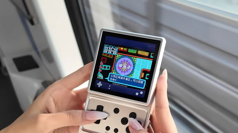 A person playing a retro console.