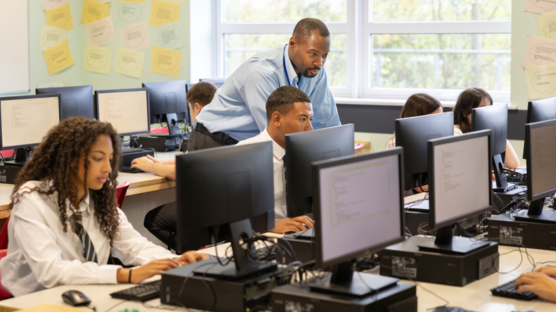 Students and teachers using computers.