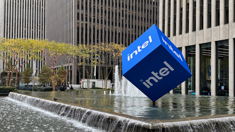 A blue cube with the Intel logo sits on a found outside an office building.