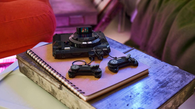 The Lego Sega Genesis Console pictured assembled on a table atop a brown spiral notebook