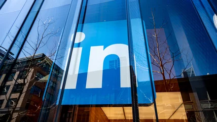 LinkedIn logo inside an office building's windows